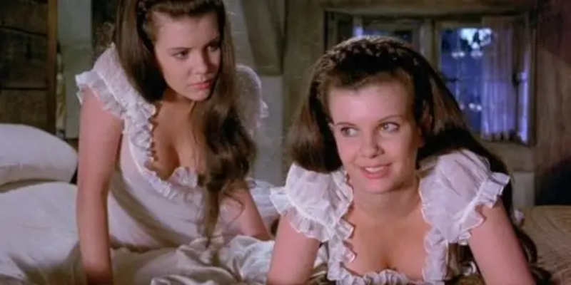 Here are the Collinsons in a still from their most famous roles—the twins in Twins of Evil